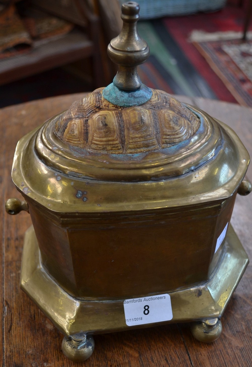 A 19th century brass table casket, tortoiseshell mounted cover, ball feet,