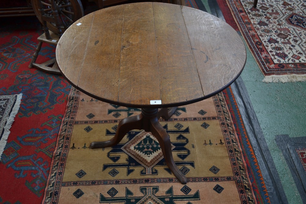 A George III oak circular tilt top tripod table