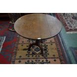 A George III oak circular tilt top tripod table