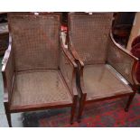 A pair of Edwardian mahogany bergere library chairs, curved rectangular backs,