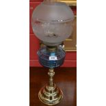 A brass and blue glass paraffin/oil lamp,