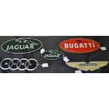 A cast metal plaque, Bugatti; others, Aston Martin, Audi,
