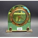 An Art Deco green plate mirror and brass mantel clock