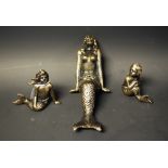 Three cast metal figures,