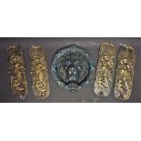 A cast metal lion head door knocker; four cast metal finger plates,