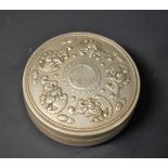 A Chinese white metal circular box, repousse bat decoration,