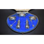 An Edwardian silver eight piece cruet set, including mustard, pair of salts,