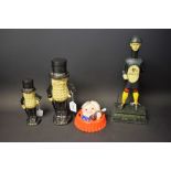 A cast metal advertising Coca Cola bottle cap money bank; a cast metal Guinness figure;