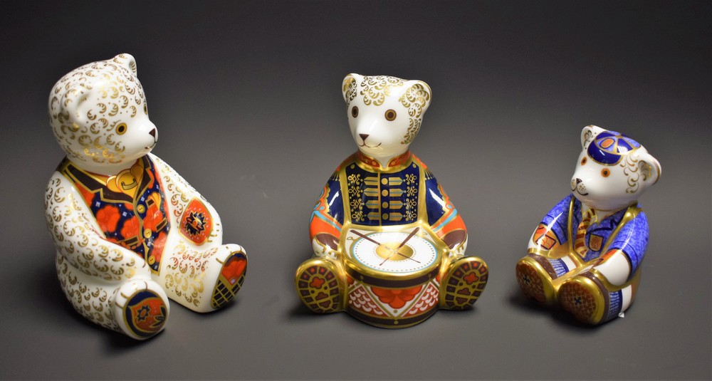 A Royal Crown Derby paperweight, Schoolboy Teddy, gold stopper; others, Drummer Teddy,