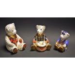 A Royal Crown Derby paperweight, Schoolboy Teddy, gold stopper; others, Drummer Teddy,