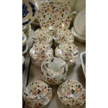 A Tuscan part tea service, in the Imari palette, printed marks, comprising cups, saucers,