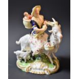 A Derby model of the Welch Tailor's Wife, she sits astride a goat with suckling kid,