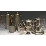 An Old Hall planished tea service comprising teapot and stand, hot water jug, creamer,