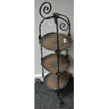 A wrought iron and copper three tier cake stand