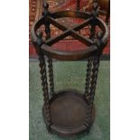 An early 20th century oak stick stand,