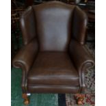 A modern brown wingback armchair