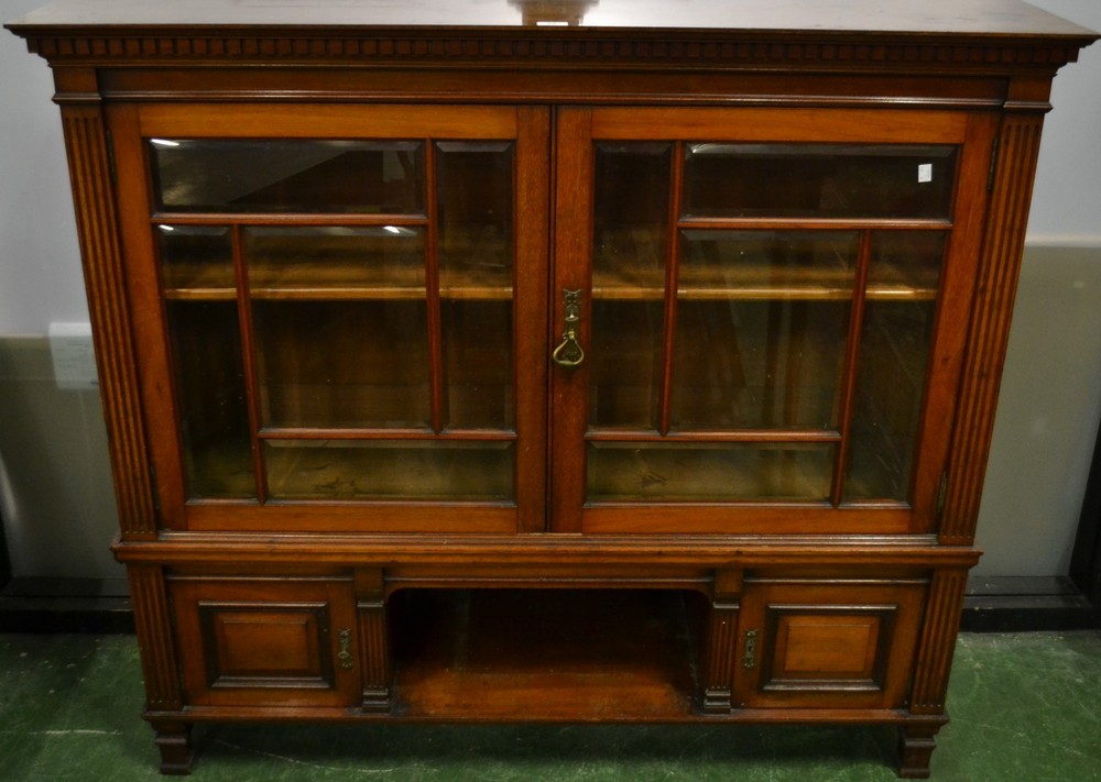 A mahogany bookcase, glazed doors enclosing an adjustable shelf,