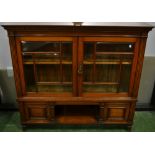 A mahogany bookcase, glazed doors enclosing an adjustable shelf,