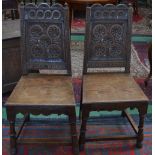 A pair of 17th century style oak hall chairs (2)