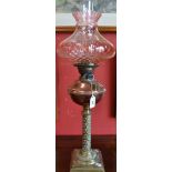 A late Victorian copper and brass oil lamp, fluted apricot shade,