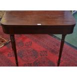 An early 20th century mahogany rounded rectangular tea table, folding top above a deep frieze,