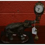 A bronzed metal swinging clock, as an elephant,