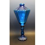 A blue glass lantern shaped candle holder,