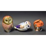 A Royal Crown Derby paperweight, Barn Owl, gold stopper; another, Owl, gold stopper; another,