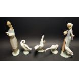 A Lladro figure, The Goose Girl; another, with a lamb; three Lladro Geese,