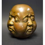 A bronzed metal Buddha head,