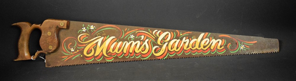 A vintage wood saw, painted decoration,