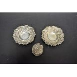 A pair of silver repousse bonbon dishes;