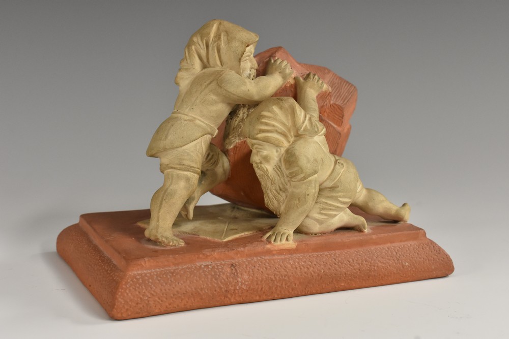 A German two-tone terracotta desk weight, modelled as two gnomes,