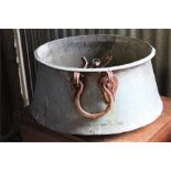 Copper planter with iron handles.