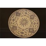 A Chinese porcelain plate, painted in underglaze blue with abstracted foliage and floral motifs, the