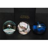 Three glass paperweights, two of which are Caithness and one is Selkirk.