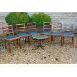 Six chairs with green cushions and a folding table