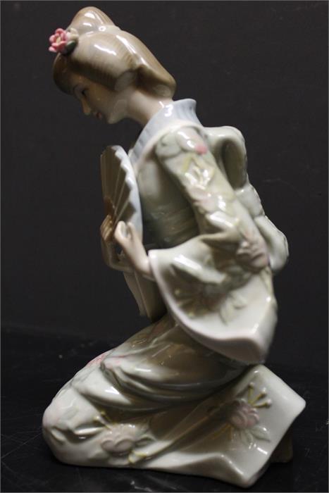 An unmarked oriental style porcelain figurine. - Image 6 of 6