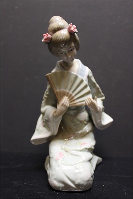 An unmarked oriental style porcelain figurine. - Image 2 of 6