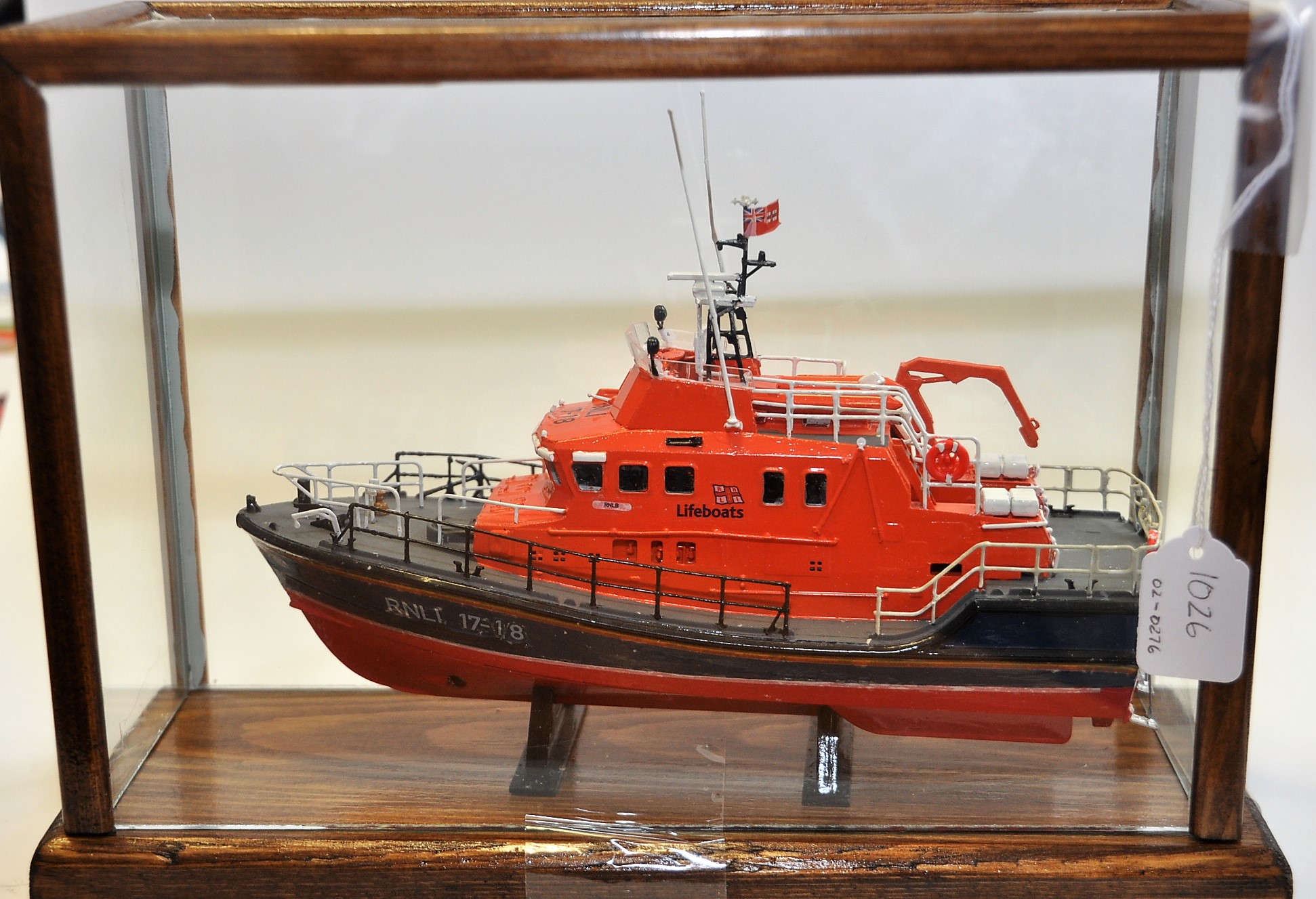 A HAND BUILT MODEL OF A LIFEBOAT IN A GLASS DISPLAY CASE (VENDORS DESCRIPTION)