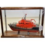 A HAND BUILT MODEL OF A LIFEBOAT IN A GLASS DISPLAY CASE (VENDORS DESCRIPTION)