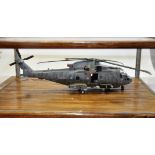 A HAND BUILT MODEL OF A MERLIN HELICOPTER IN A GLASS DISPLAY CASE (VENDORS DESCRIPTION)