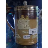 ROYAL DOULTON EMBOSSED TANKARD WITH SILVER COLLAR DEPICTING HUNTING SCENE.