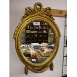 OVAL GILT FRAMED MIRROR WITH BOW EFFECTS (30 X 44 CM)