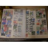 STAMP ALBUM CONTAINING HUNDREDS OF VARIOUS STAMPS