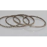 Four various silver bangles