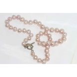 Pink pearl necklace with heart shaped silver clasp