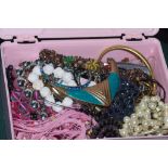 Pink plastic box filled with costume jewellery