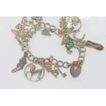 Silver charm bracelet with heart padlock