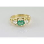 18ct yellow gold, oval emerald & 2 diamond ring